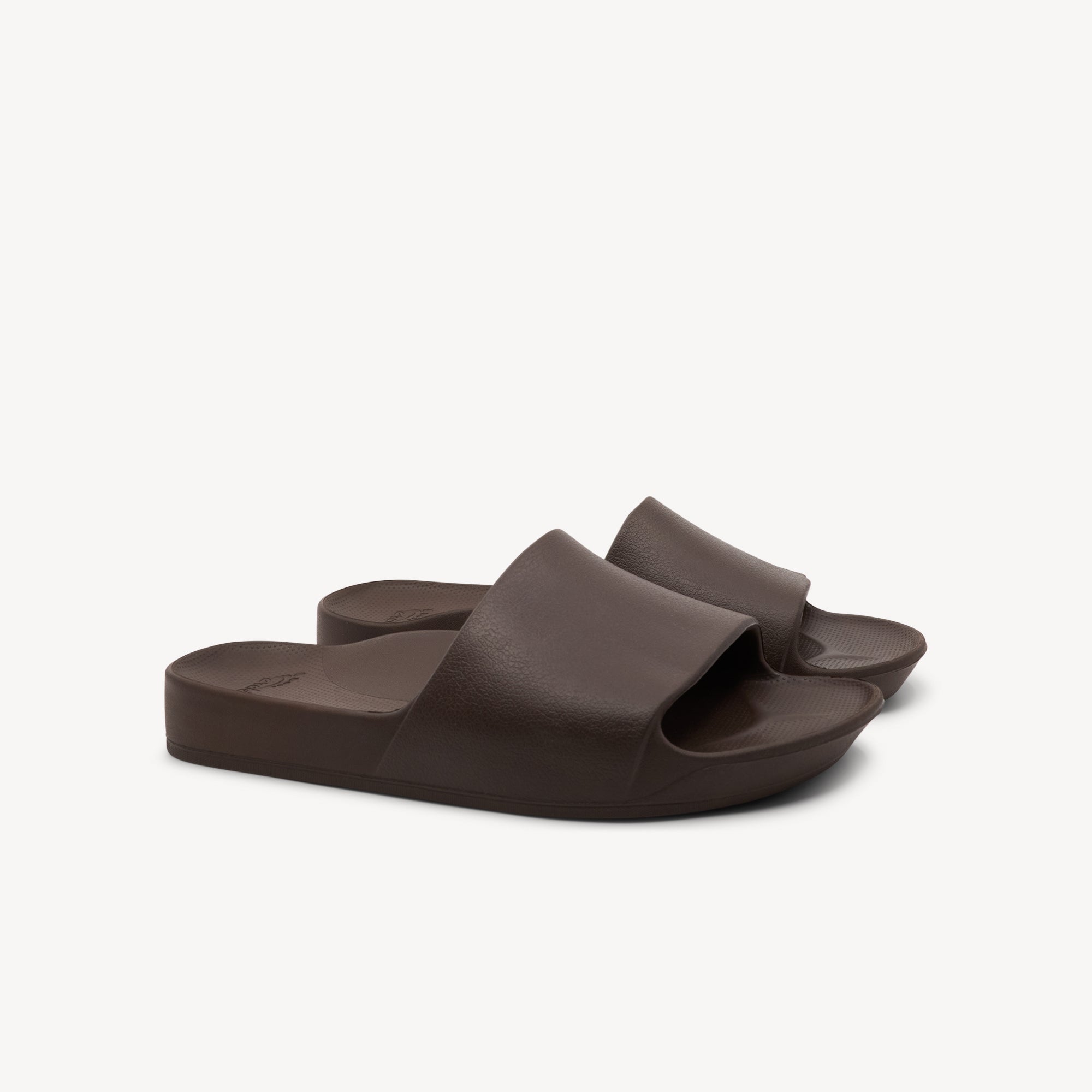 Side view of Archies Slides Brown features 2.2cm arch support at Profeet Footwear. Single-mould design for durability and all-day comfort. Shop now.