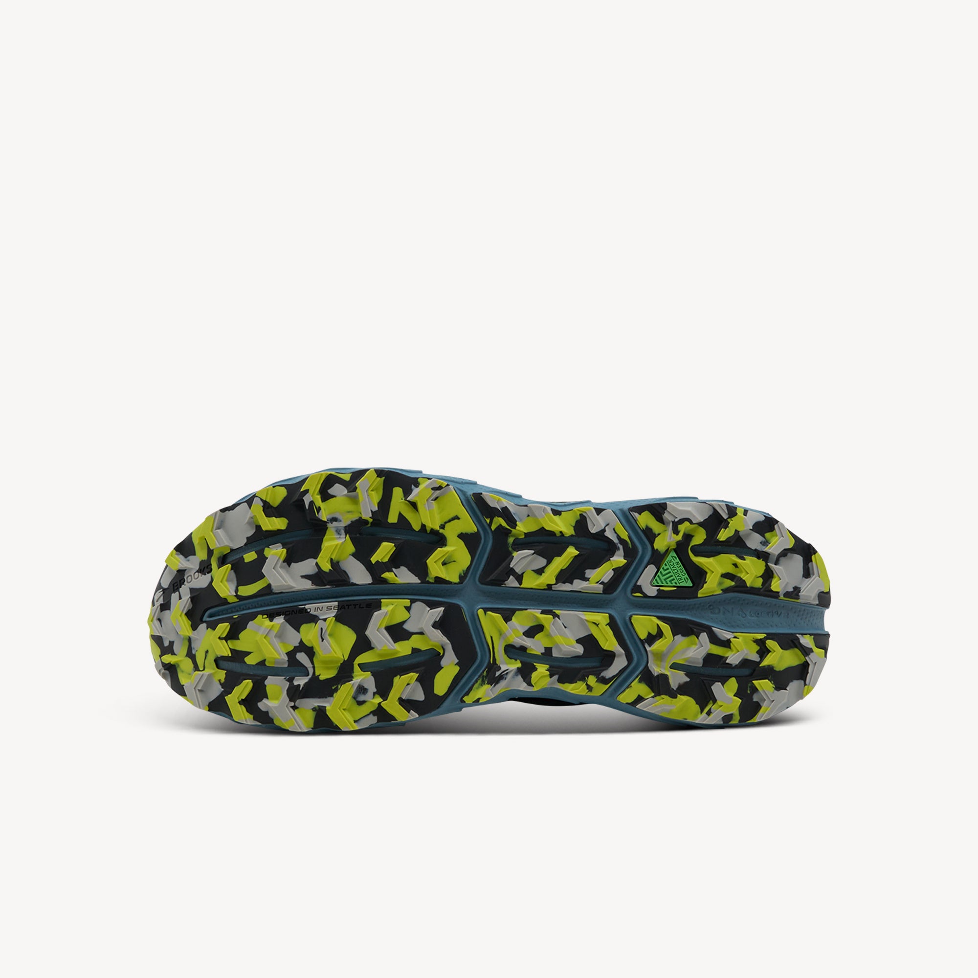 Outsole view of Brooks Cascadia 18. TrailTack Green Rubber Outsole features sticky grippy rubber with 3.4-4.5mm deep aggressive lugs. Shop now at Profeet Footwear.