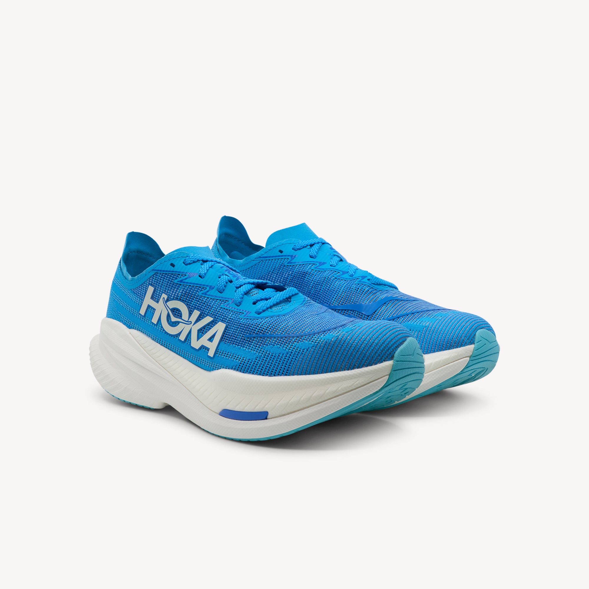 Side view of Hoka Mach X 2 features race-ready speed at Profeet Footwear. Propulsive plated trainer with maximum cushioning and aggressive rocker for tempo runs. Shop now.