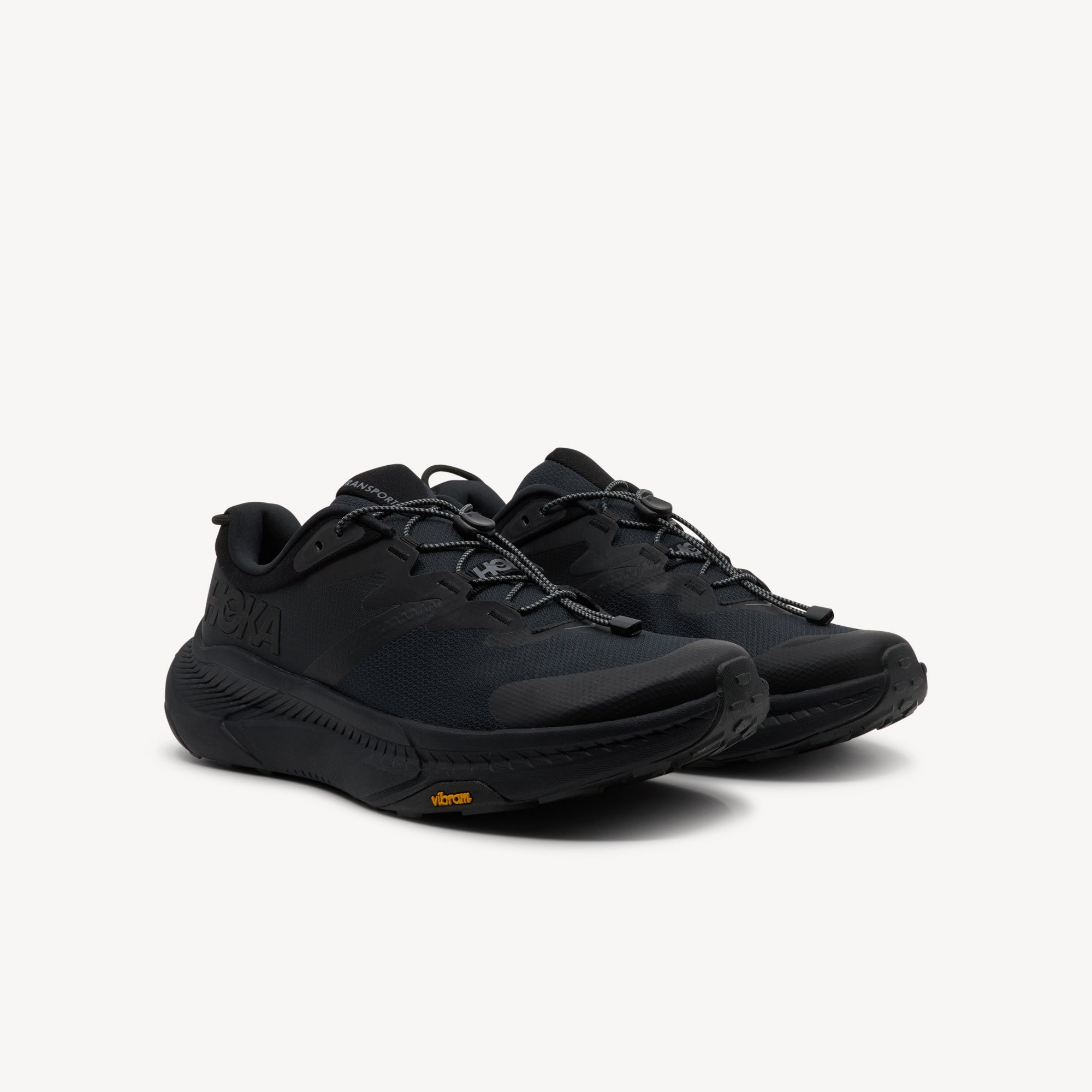 Side view of Hoka Transport features recovery comfort at Profeet Footwear. Plush cushioned slide with extended heel geometry for relaxed wear. Shop now.