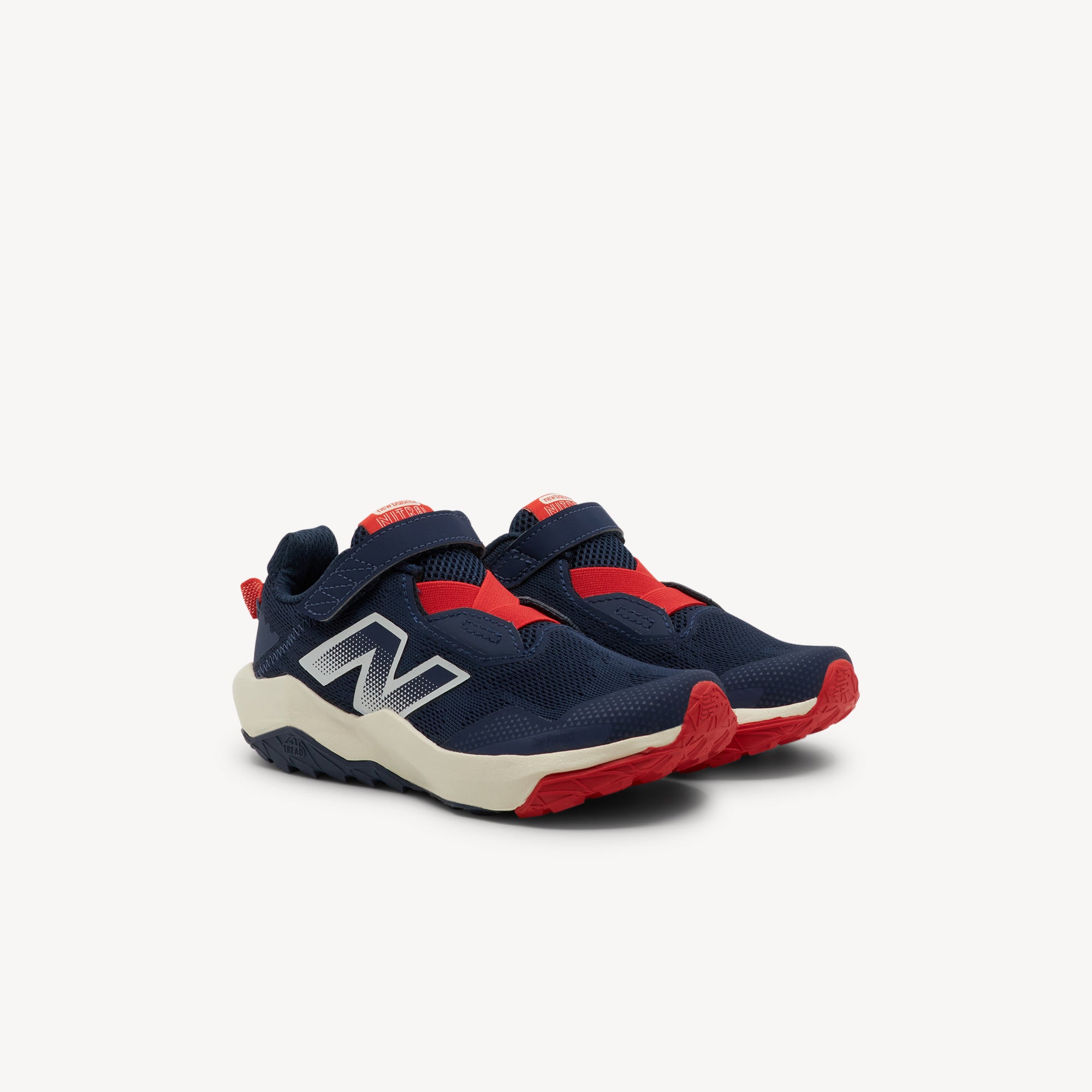 Side view of New Balance Nitrel v6 Navy/Sea Salt PS Kids features plush DynaSoft midsole, AT Tread outsole for mixed terrain and no‑sew overlays for busy young feet. Shop now.