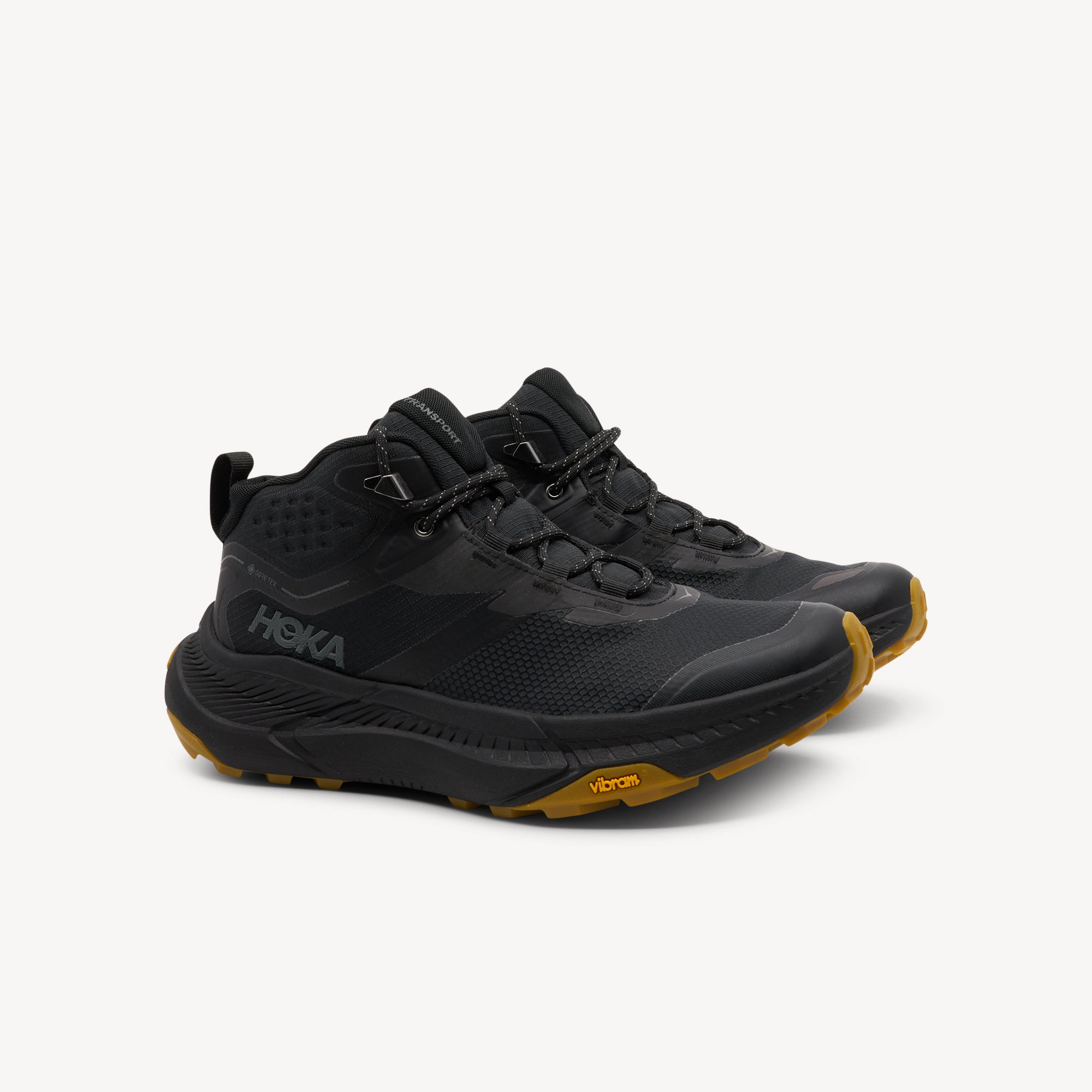 Side view of Hoka Transport Hike GTX features town-to-trail versatility at Profeet Footwear. Low-profile waterproof chukka with speed lace hooks. Shop now.