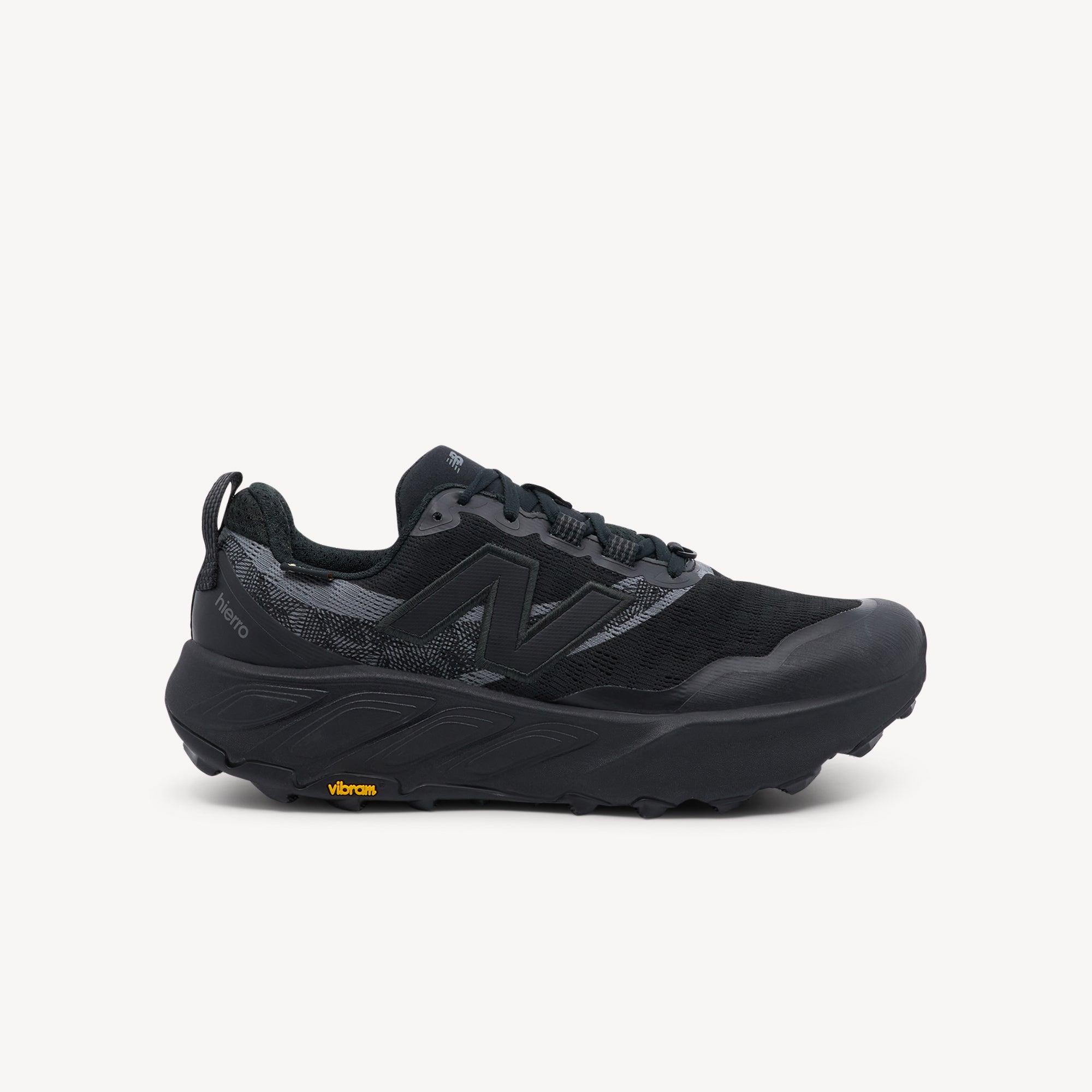 New Balance Fresh Foam X Hierro v9 men's trail running shoe in black cement colorway showing maximum cushioned dual-density midsole and Vibram Megagrip outsole available at ProFeet Footwear